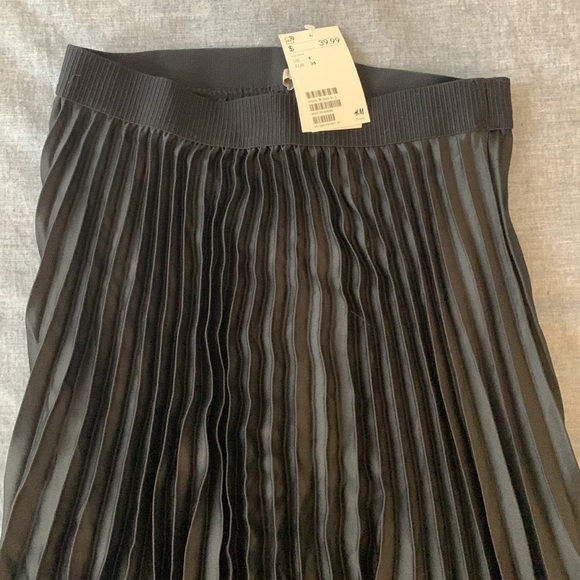 Black, mid length skirt. H&M size 4. Looks like black silk. - Picture 2 of 2